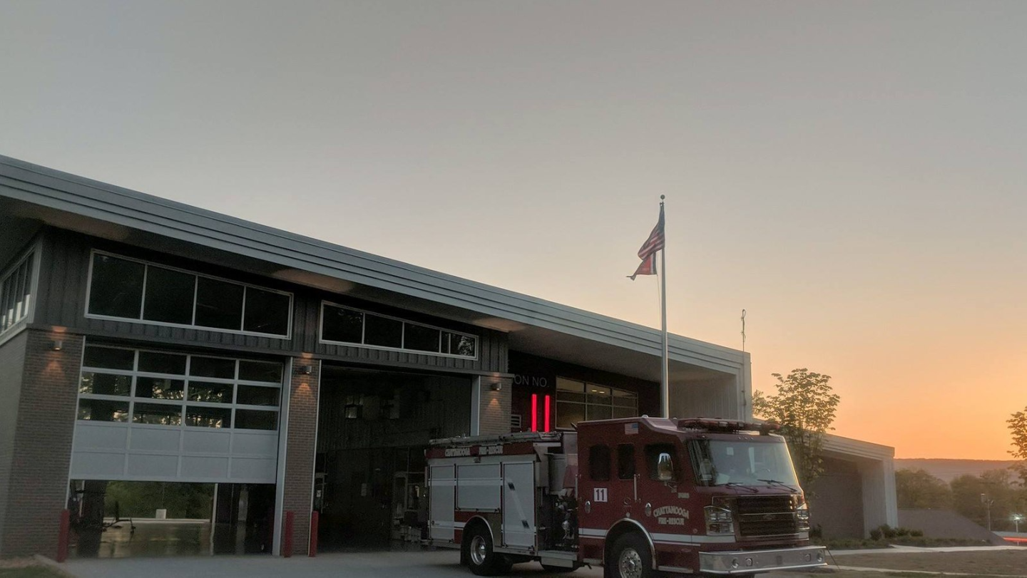 Fire truck parked outside Fire Station 11 at sunset.