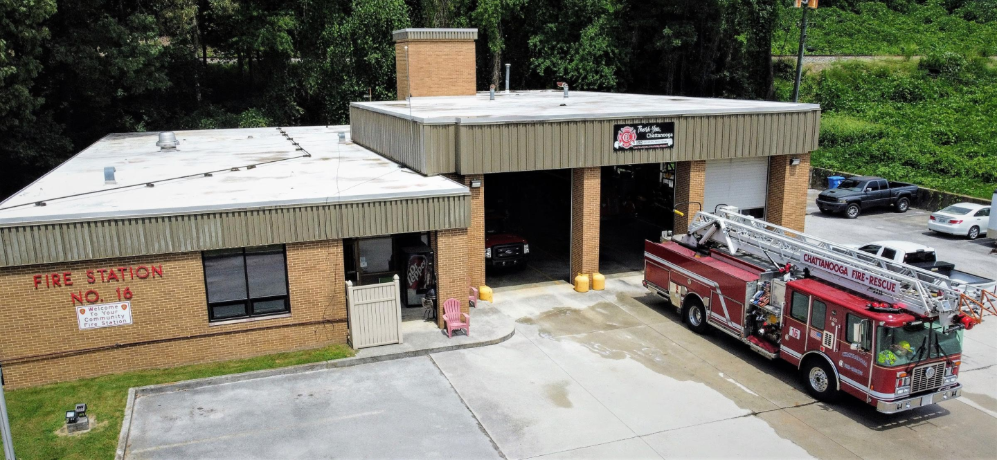 A fire truck parked in front of a building at fire station 16.