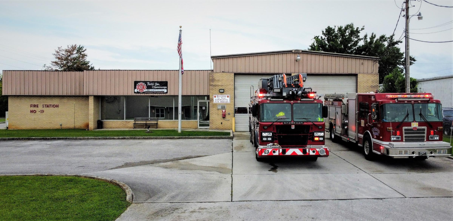 Fire station 19 with two fire trucks parked in front of the building.