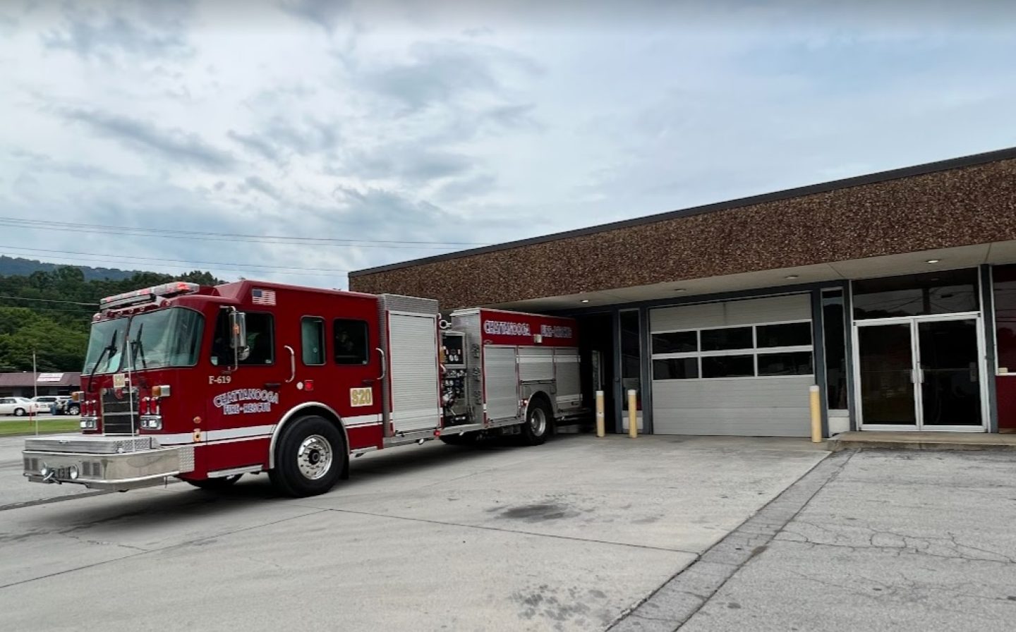 Side view of a fire truck parked in front of a building at fire station 20.