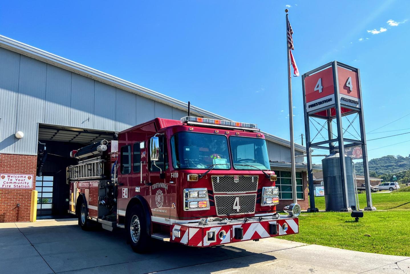 Red fire truck parked in front of building at fire station 4.