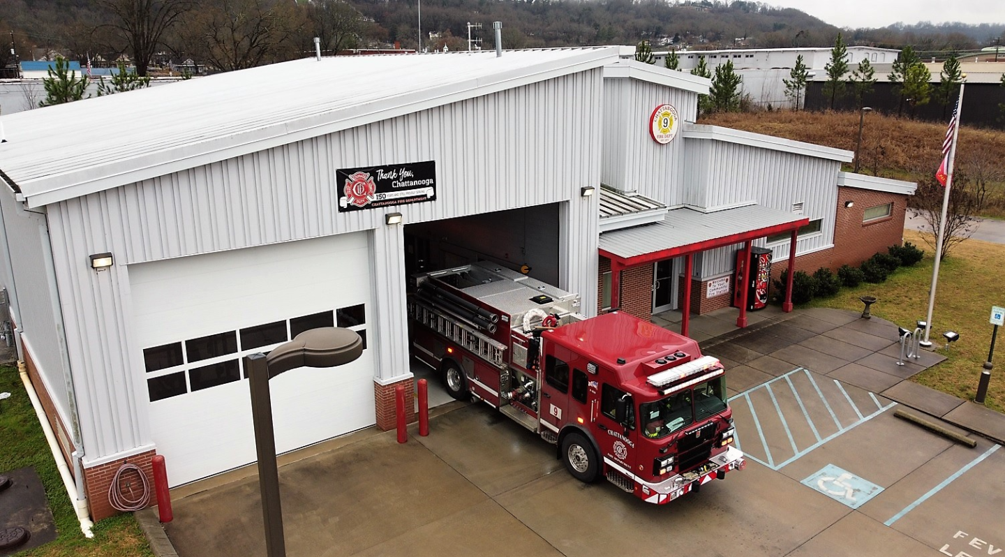 A fire truck parked in front of a building at fire station 9.