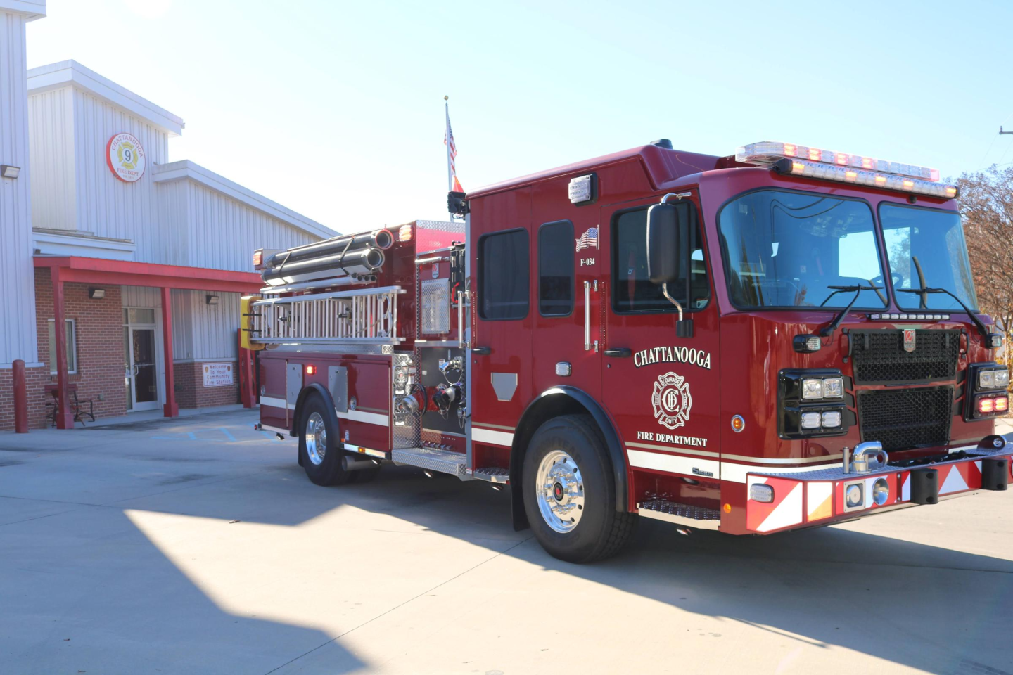 Red fire truck parked in front of building at fire station 9.