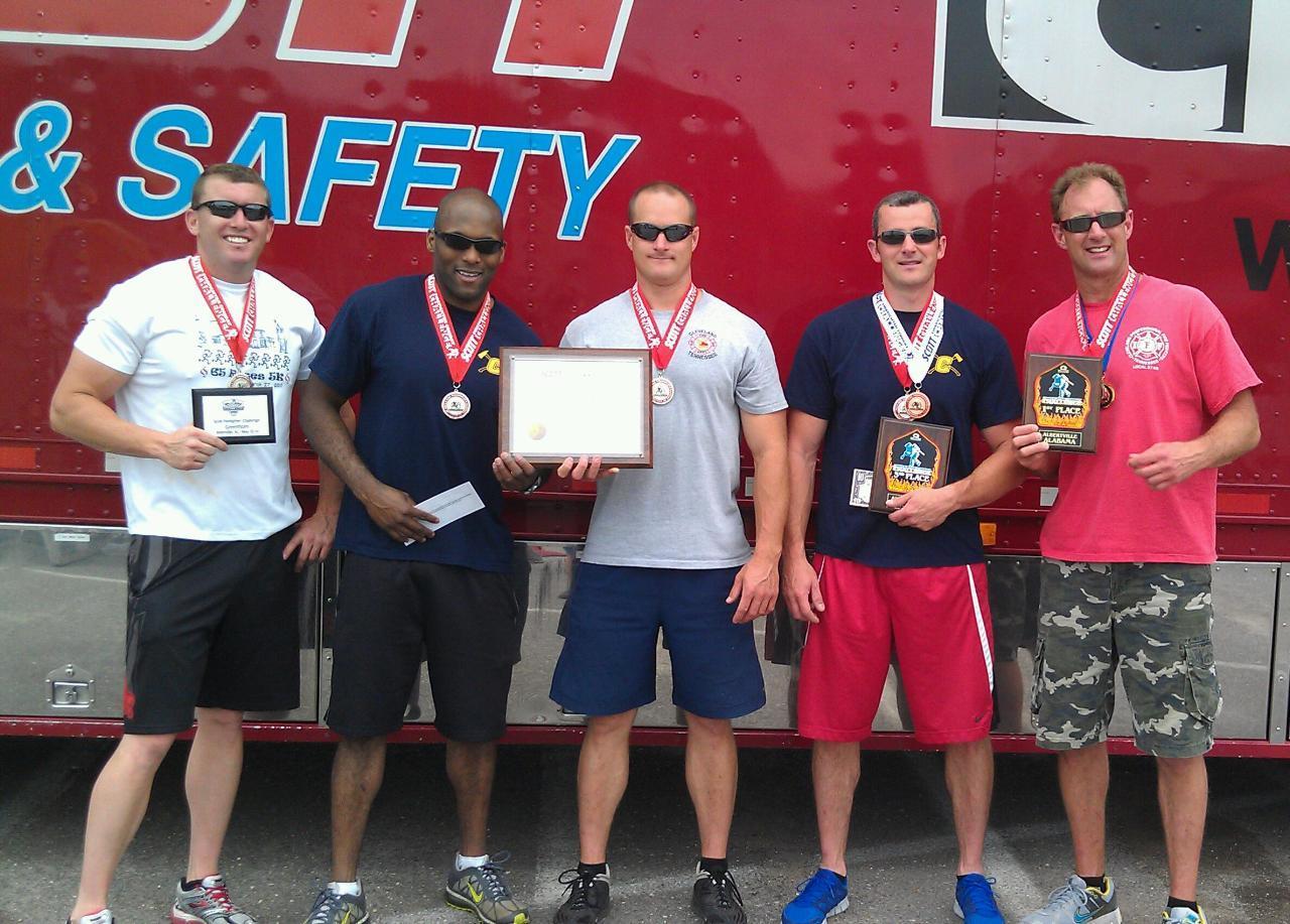 A group of men proudly displaying their awards, celebrating their achievements together.