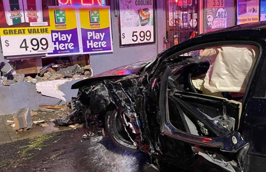 Car strikes store, catches fire