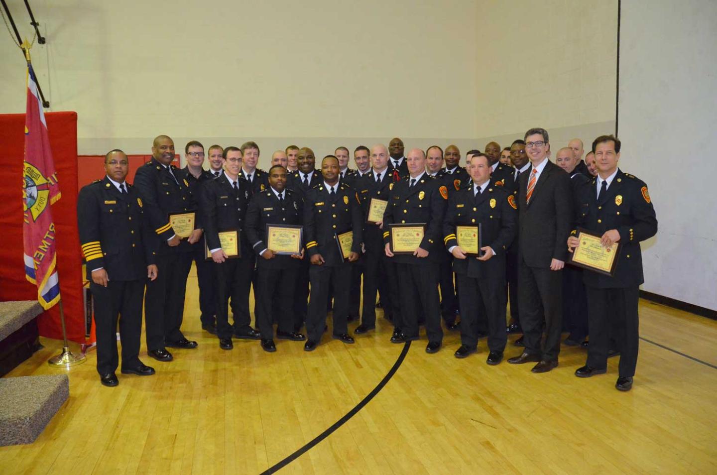 The Chattanooga firefighters who received promotions last year, along with Mayor Andy Berke and Fire Chief Lamar Flint.