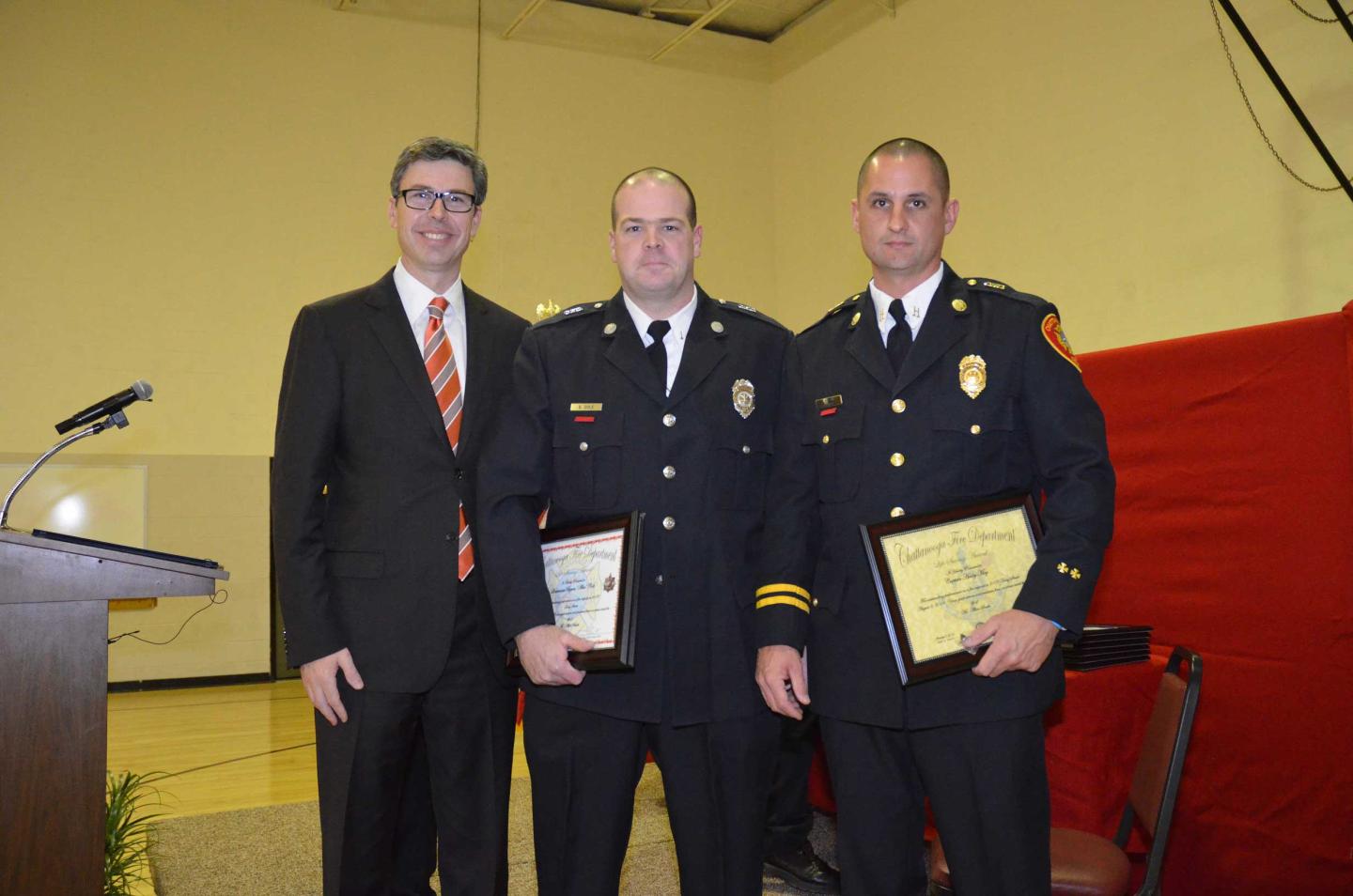 Lt. Alex Cole (middle) and Captain Ashley May (right), Firefighters of the Year for 2014, received their certificates from Mayor Berke.