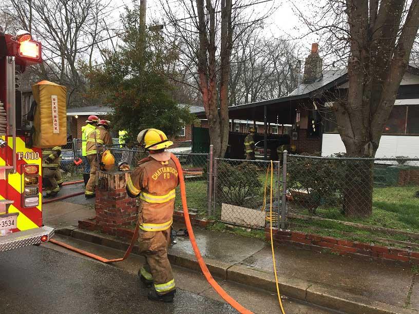 Firefighters Carry Another Woman from a Burning Home