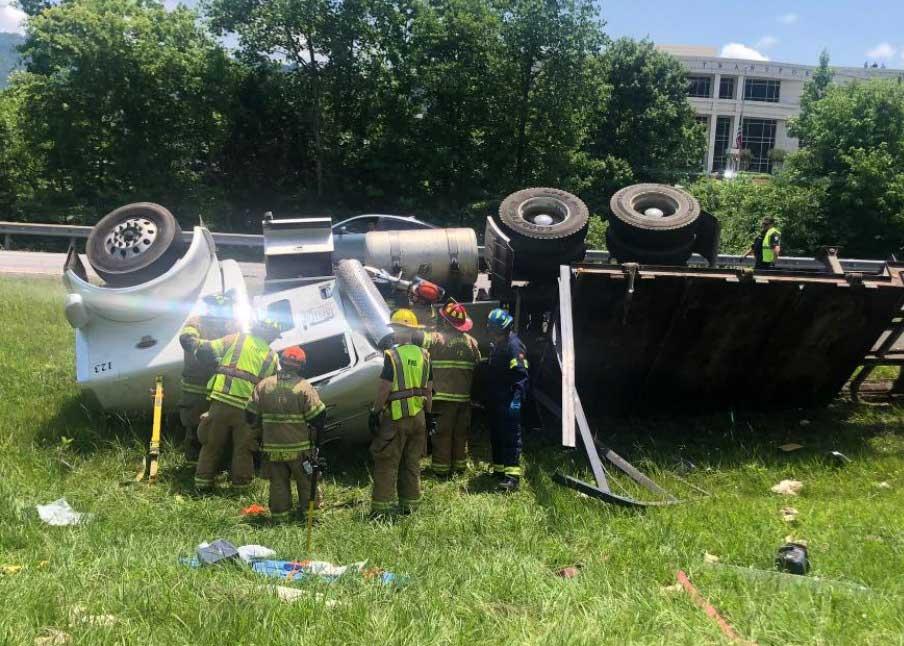 Firefighters extricate driver from overturned chicken truck