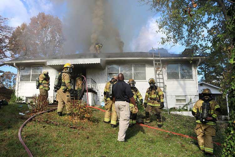 Firefighters Pull Woman from Burning Home